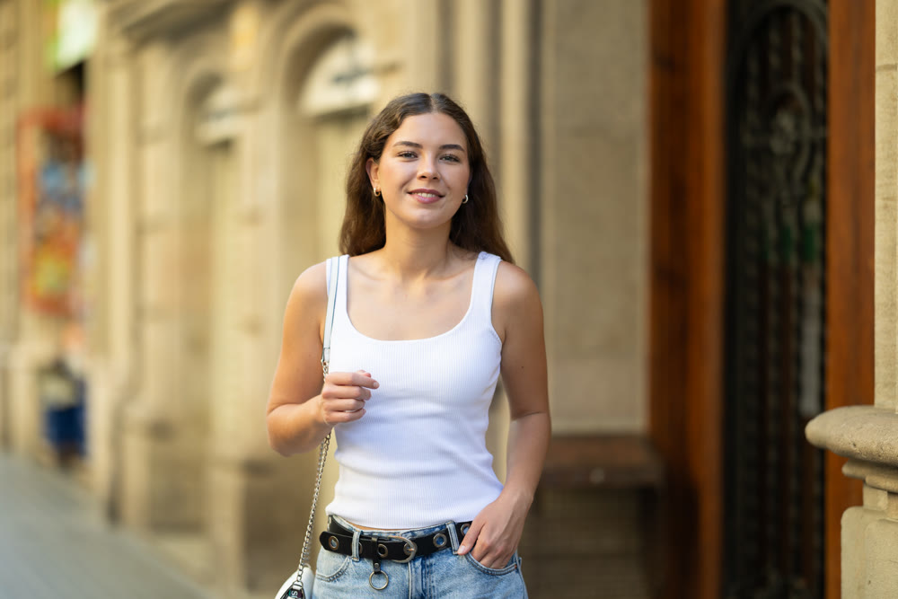Young girl enjoying walk along summer city stree