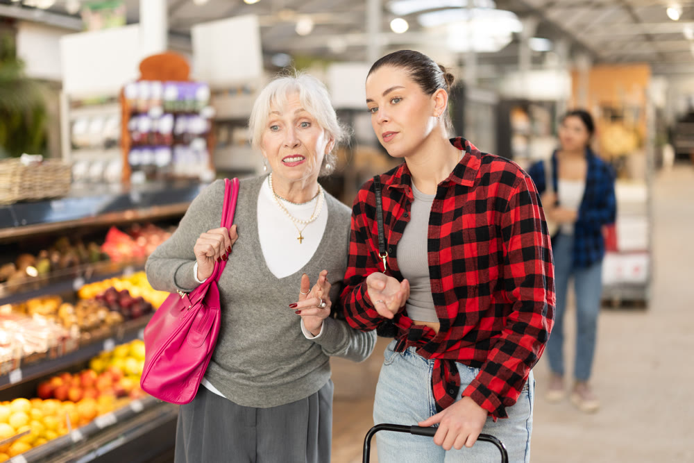 Young and elderly woman choosing groceries at store