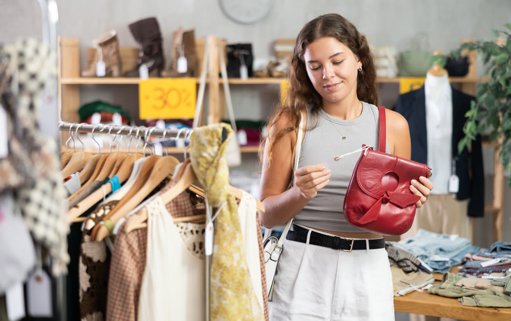 Young women choosing handbag in store