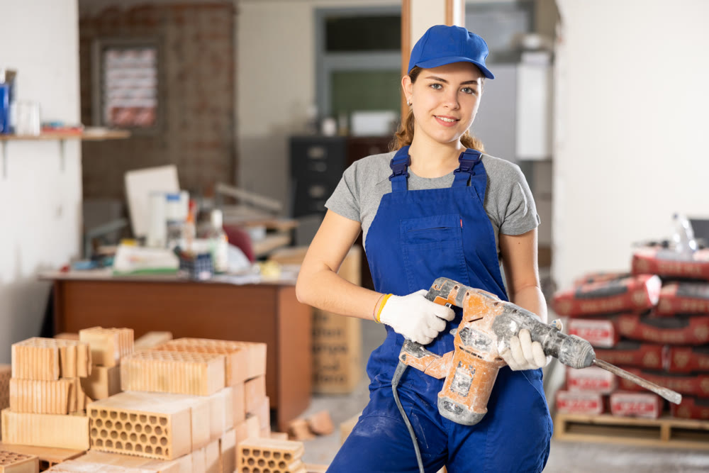 Female worker posing on indoor construction site