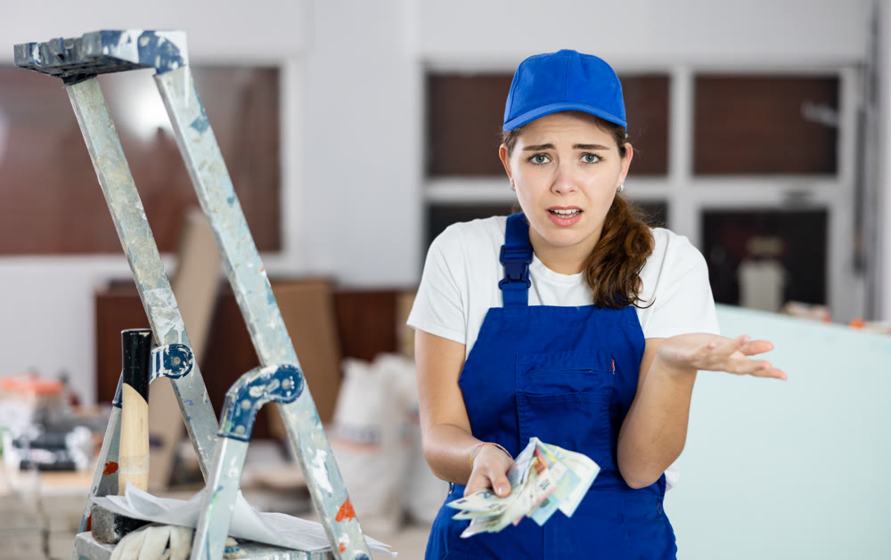 Frustrated woman builder is unhappy with earned money
