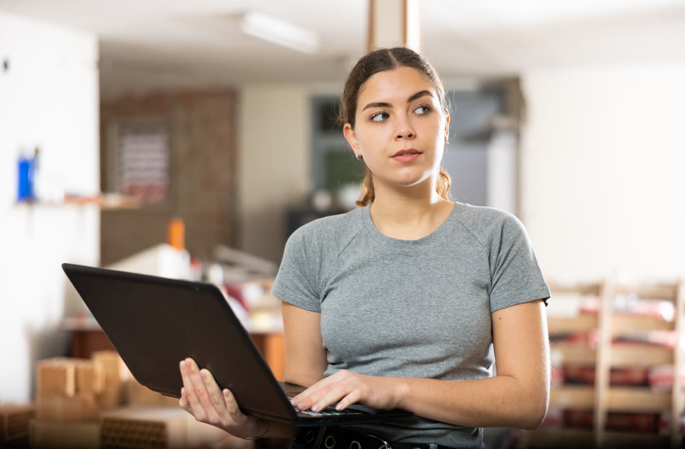 Girl using laptop to find interior design during house renovation