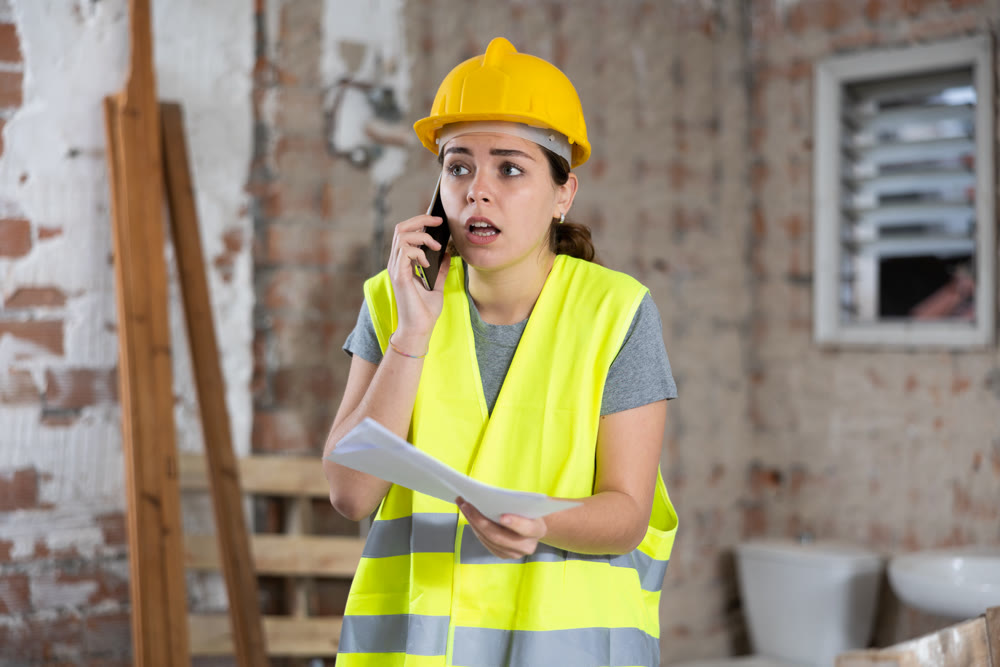 Woman talking on phone at building site