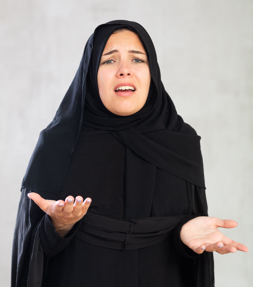 Worried young woman dressed in traditional islamic clothes