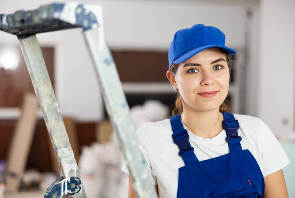 Woman builder standing in apartment