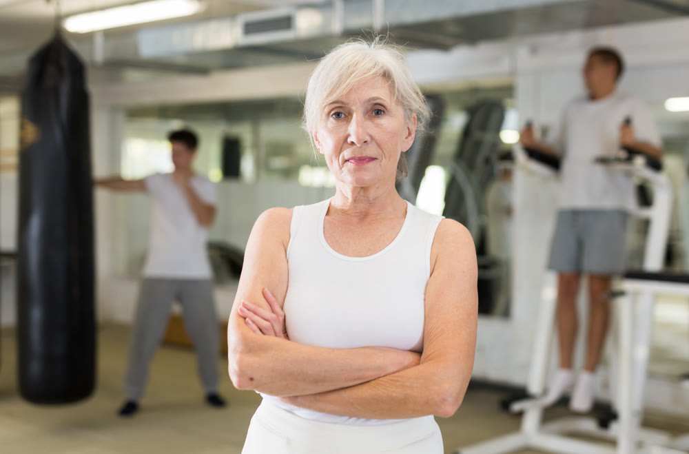 Portrait of mature woman in gym for self defense exercises