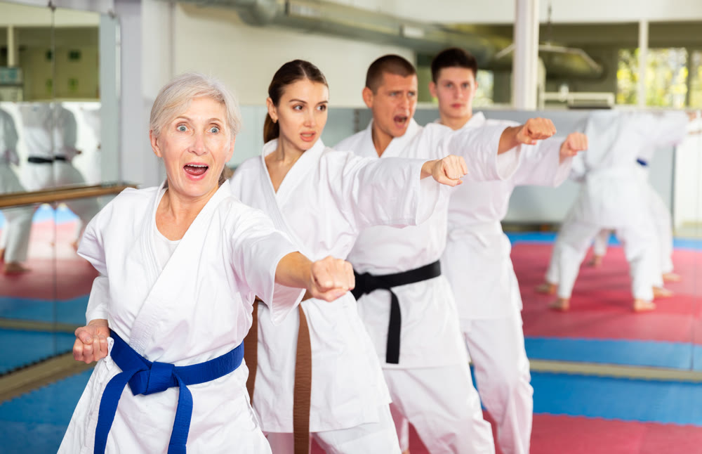 Group lesson in karate or taekwondo in gym. Practicing blows