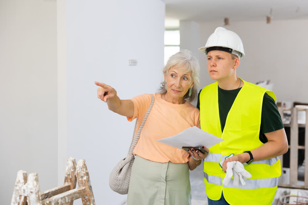 Teenager helping senior woman with home improvement works