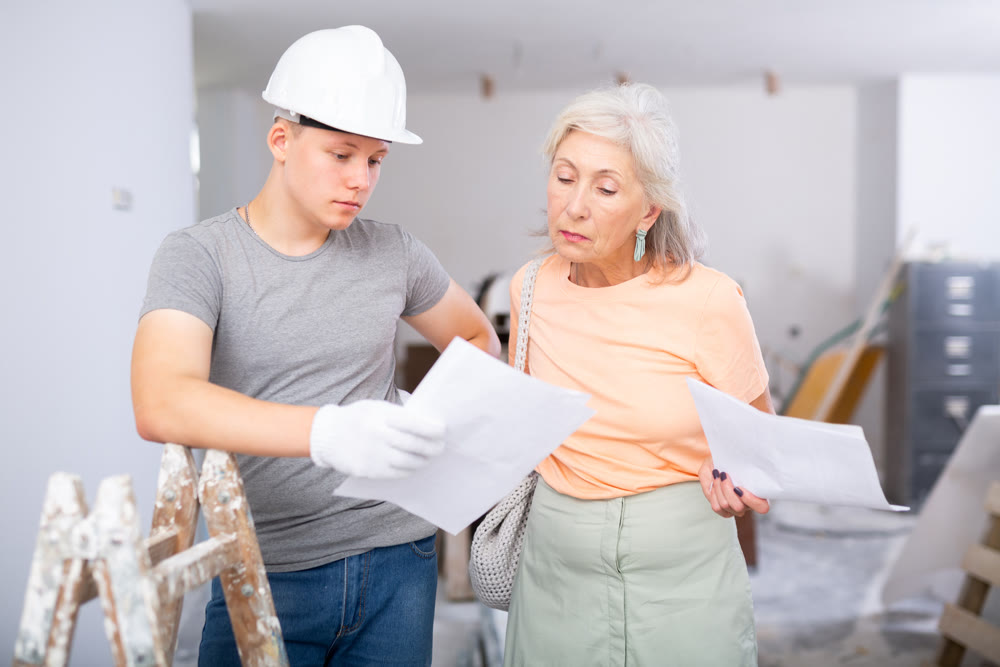 Teenager helping senior woman with home improvement works