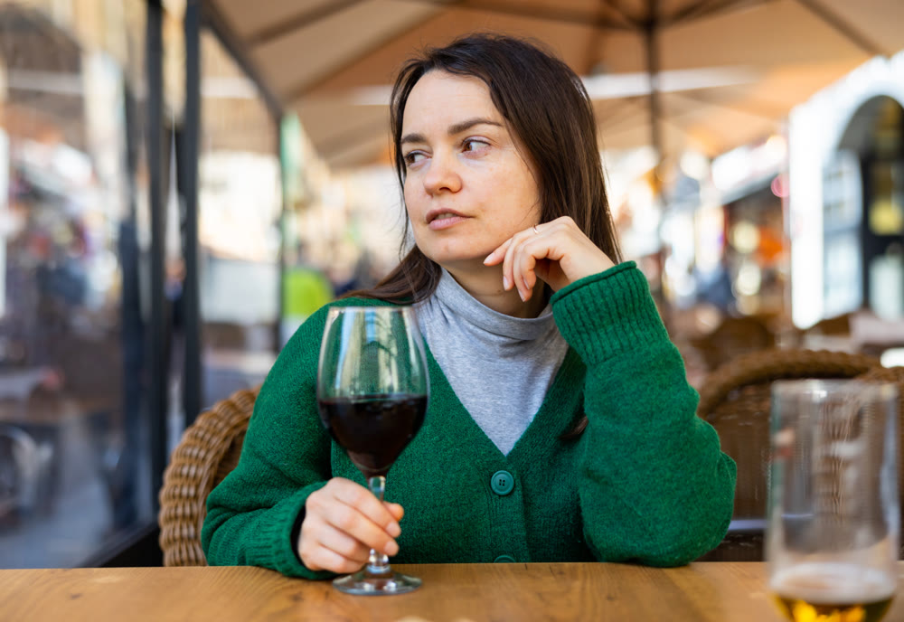 Portrait of woman drinking red wine in diner
