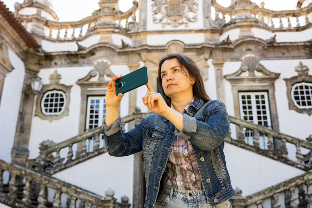 Woman tourist with phone, Vila Real, Portugal