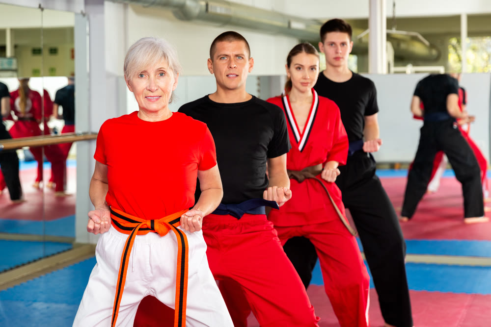People of different ages performing kata in gym