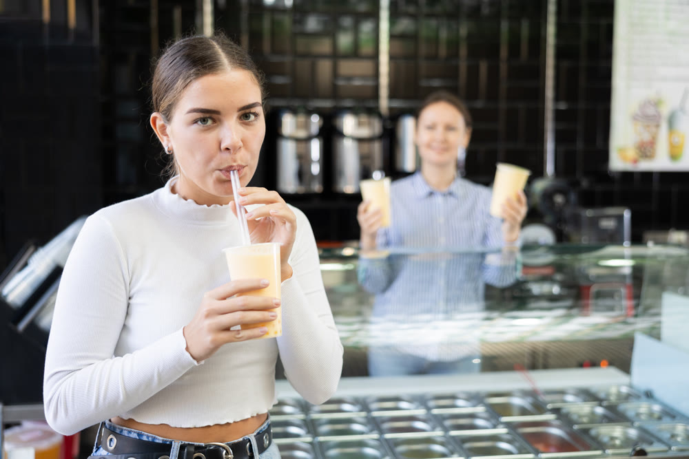 Young girl savoring taste of popular Taiwanese refreshing bubble tea