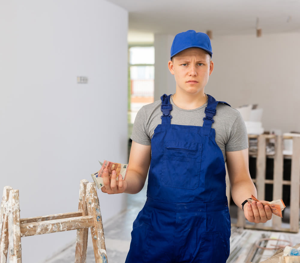Discontented teenager with bunch of money he earned on first job in building site