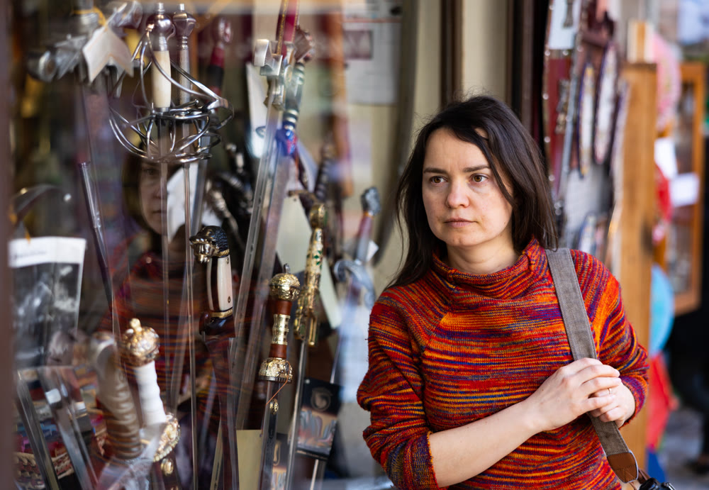 Woman tourist chooses souvenirs traditional for city of Toledo. Spain
