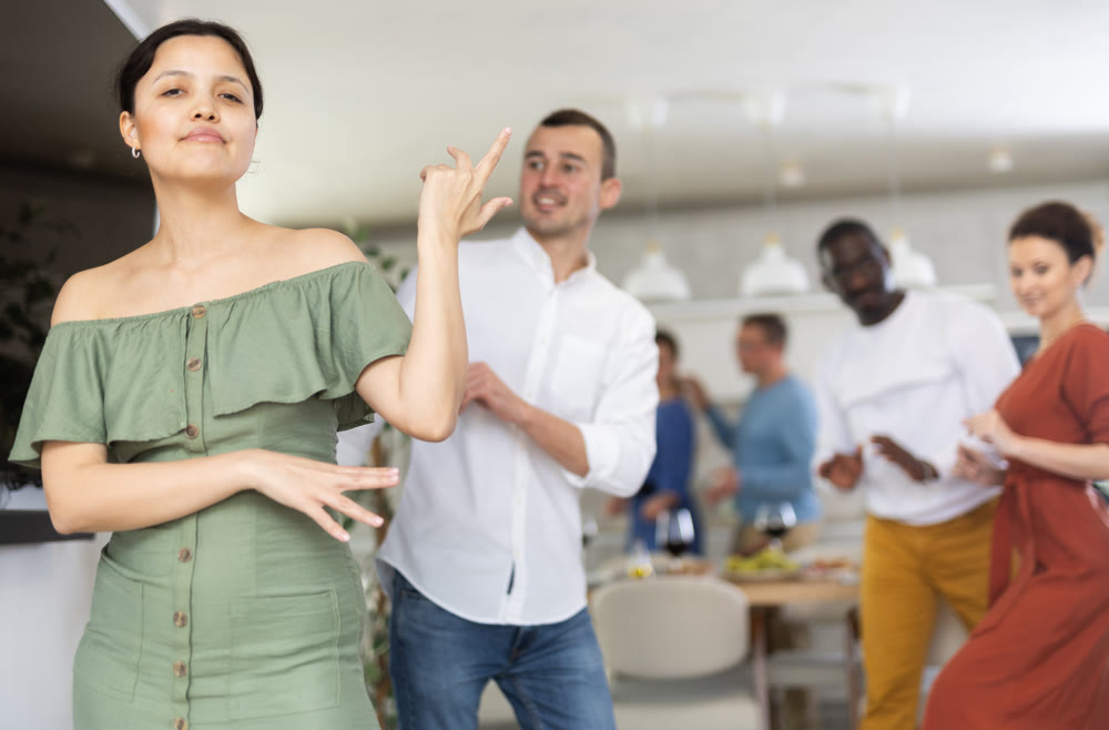 Happy middle-aged men and women doing quick dance in pairs