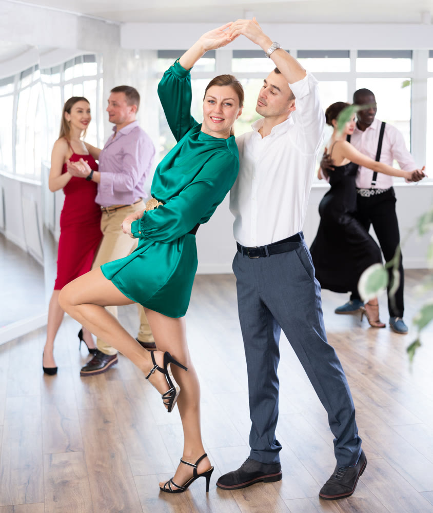 Man and woman dancing waltz in couple during lesson at studio