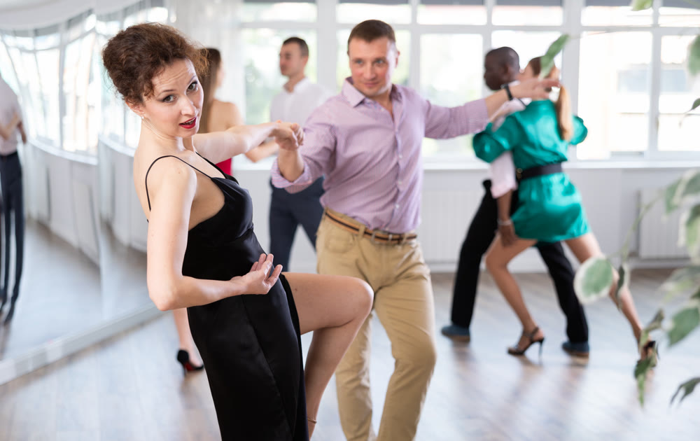 Man and woman practicing swing dance in dancing studio