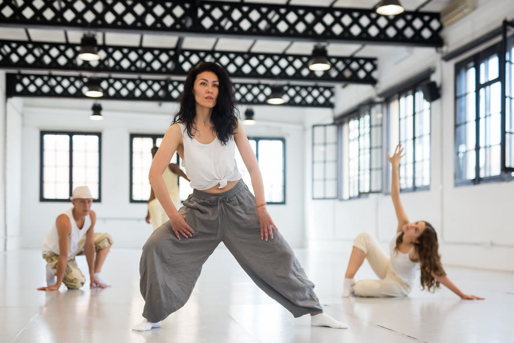 Asian woman studying movement of contemporary dance