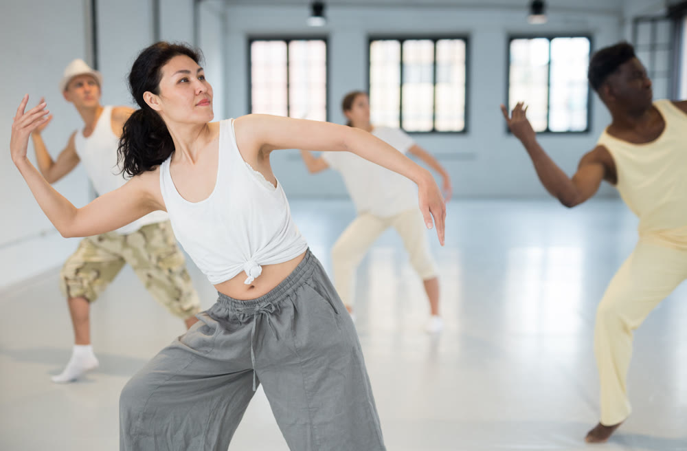 Asian woman studying movement of contemporary dance