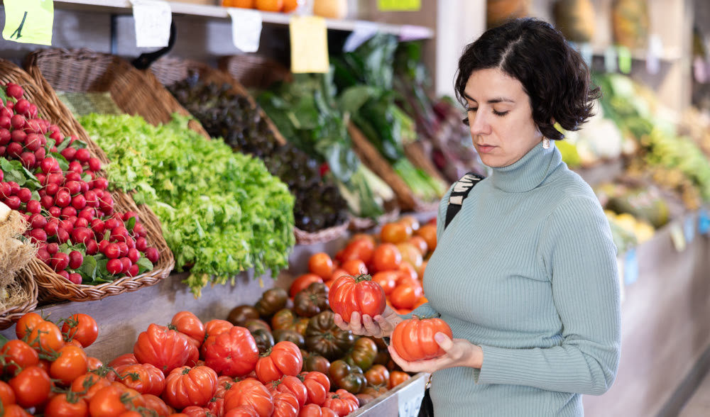 European woman choosing tomatoes