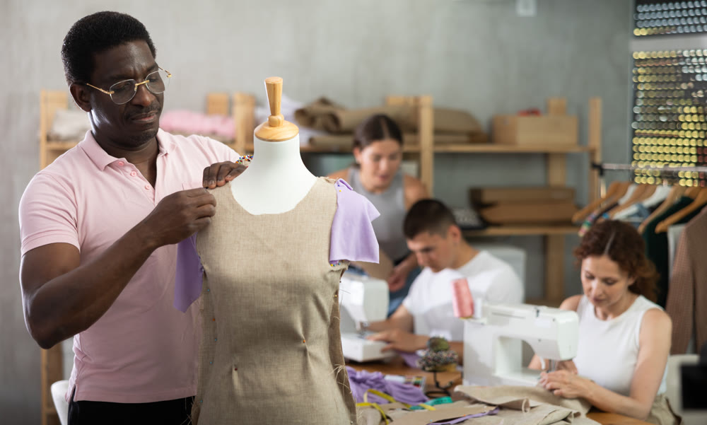 Middle-aged man working with mannequin in workshop