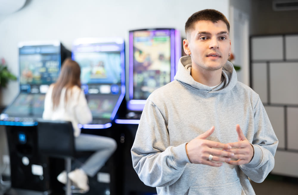 Young man in hall with slot machines