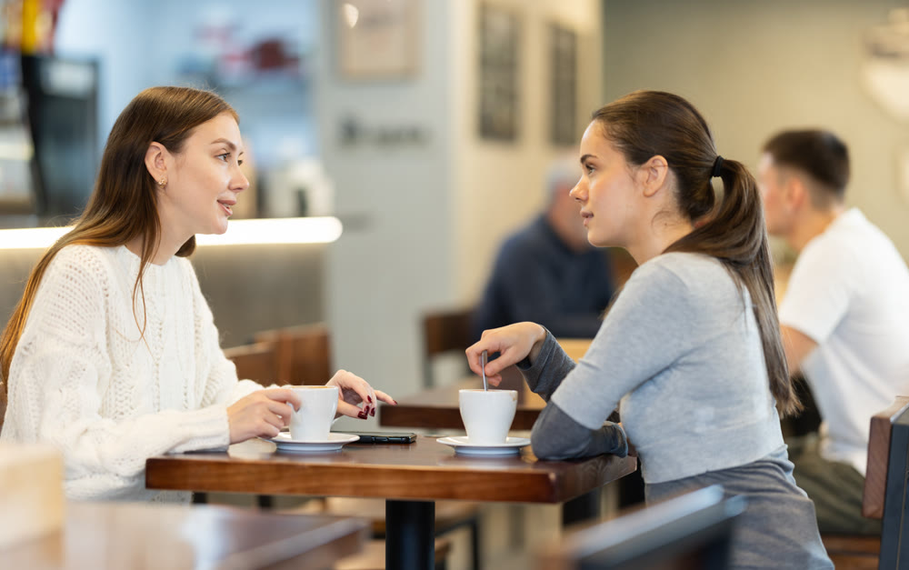 Two women chatting in a coffee shop