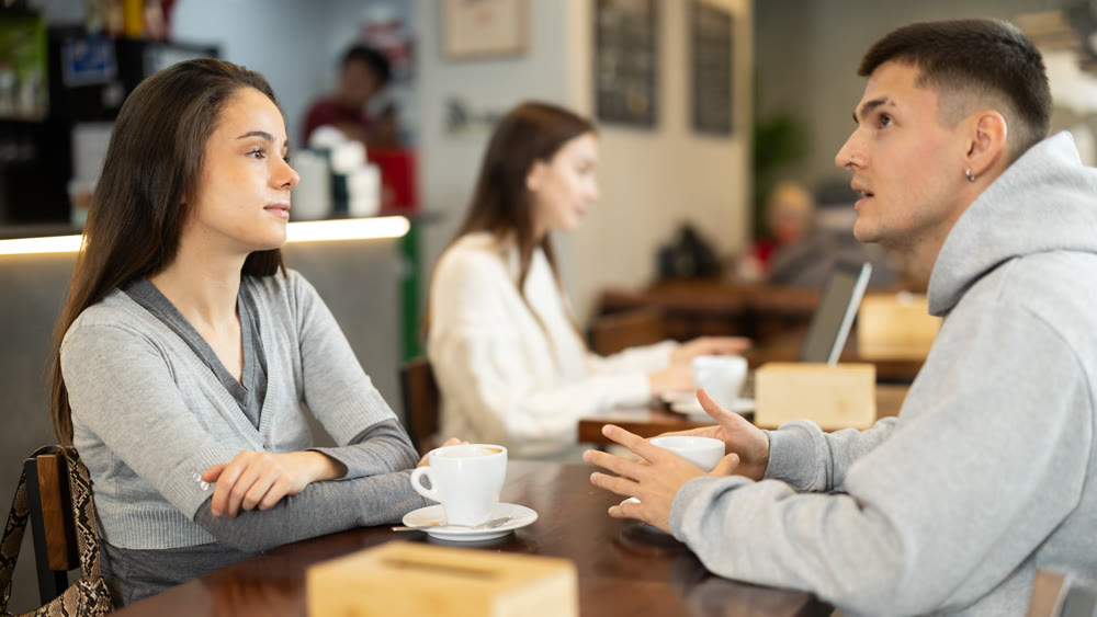 Girl in cafe sits near guy companion, has nice conversation
