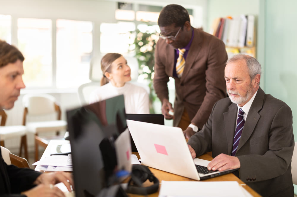 Mature man working in a team in an office