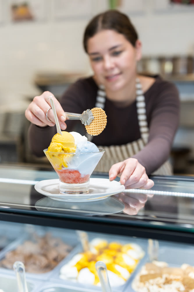 woman on a cafe seller offers ice cream