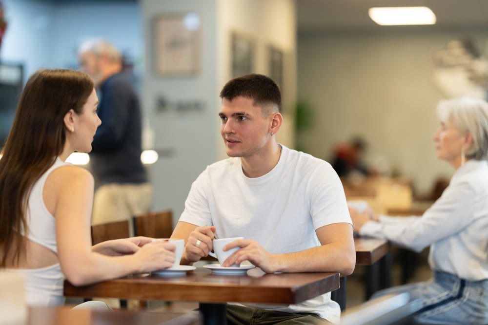 Girl in cafe sits near guy companion, has nice conversation