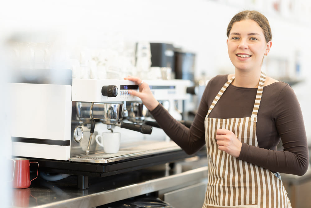 Girl coffee shop employee at work