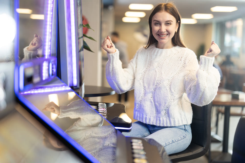 Girl is playing slot machines in casino