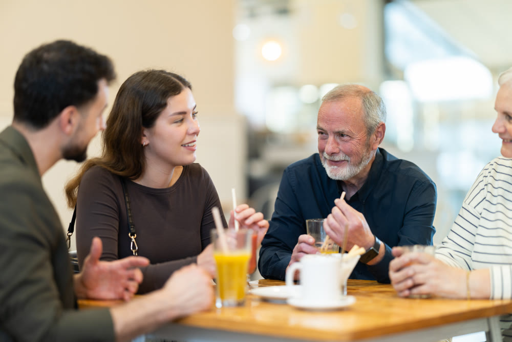 Family day. Multiage family drink coffee or juice in restaurant