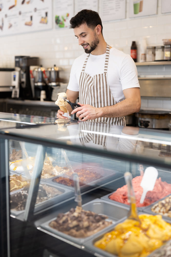 guy working in a cafe offers ice cream