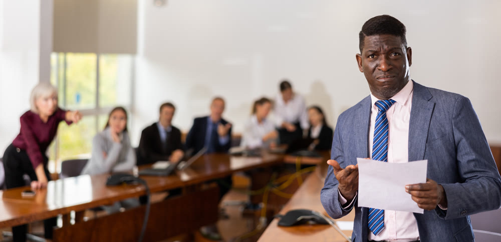 Portrait of depressed businessman in suit with documents