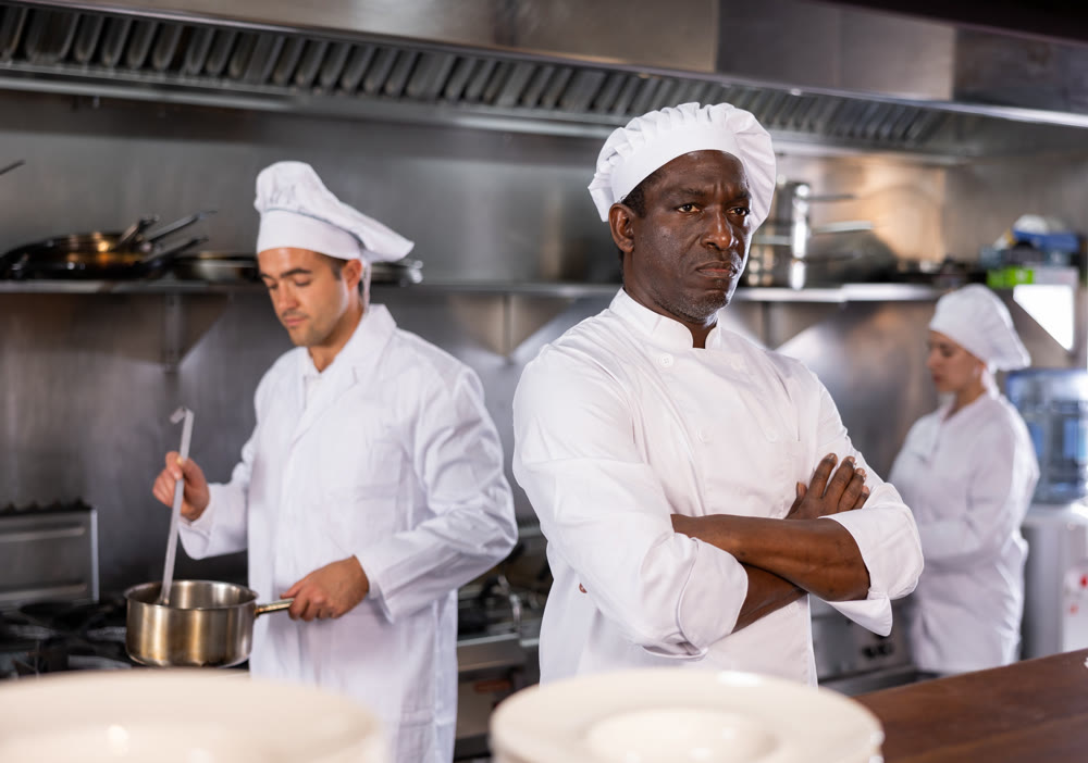 Man head chef posing in restaurant kitchen