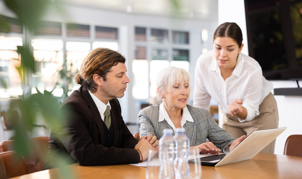 Business colleagues planning work in meeting at table in office