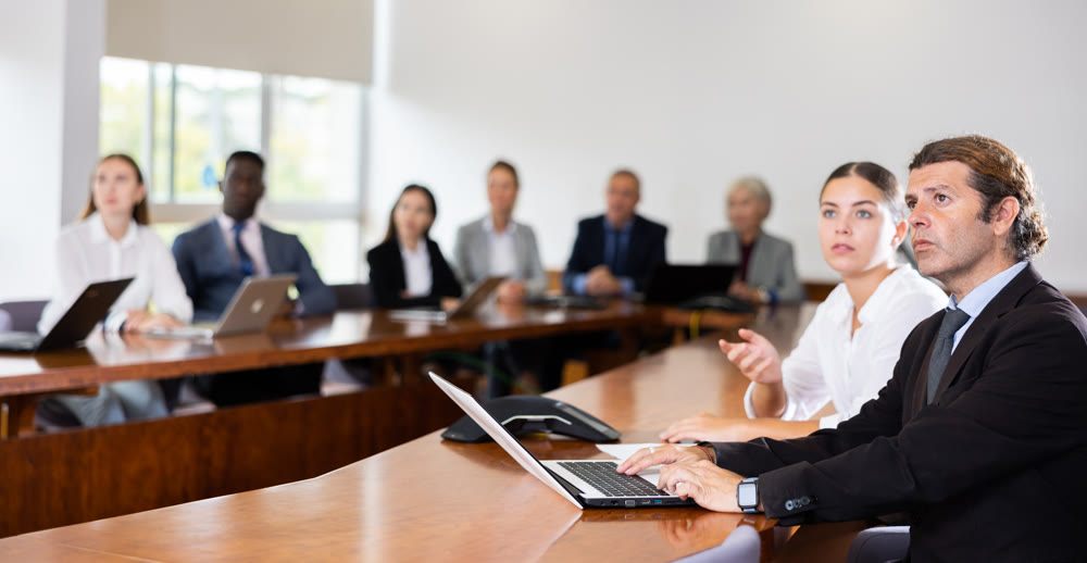 Man using laptop during meeting in company office