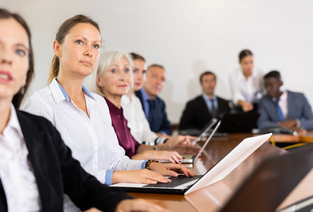 Portrait of business woman using laptop at business meeting