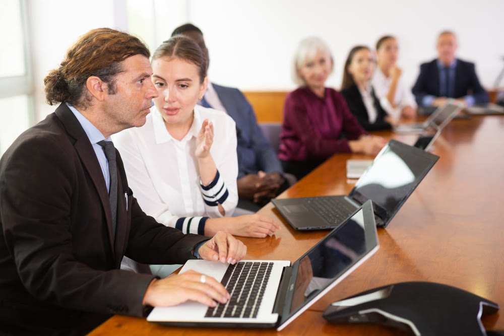 Female secretary chatting with her boss during conference