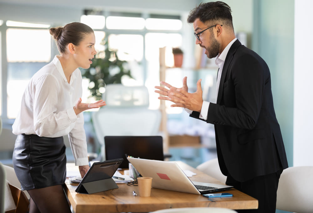 Man and woman arguing in the middle of the office