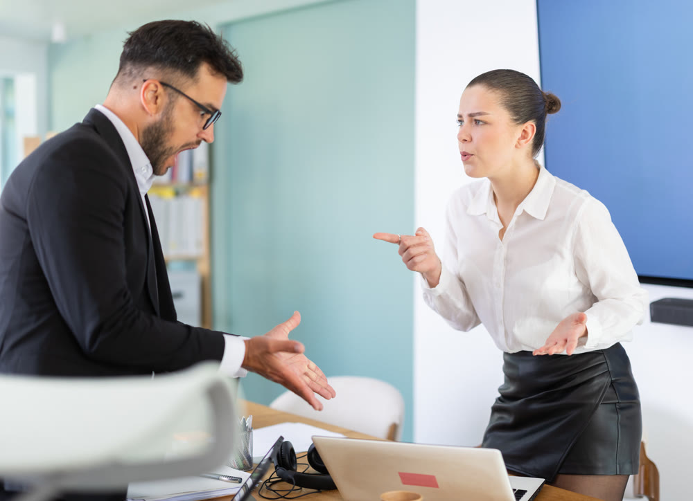 Man and woman arguing in the middle of the office