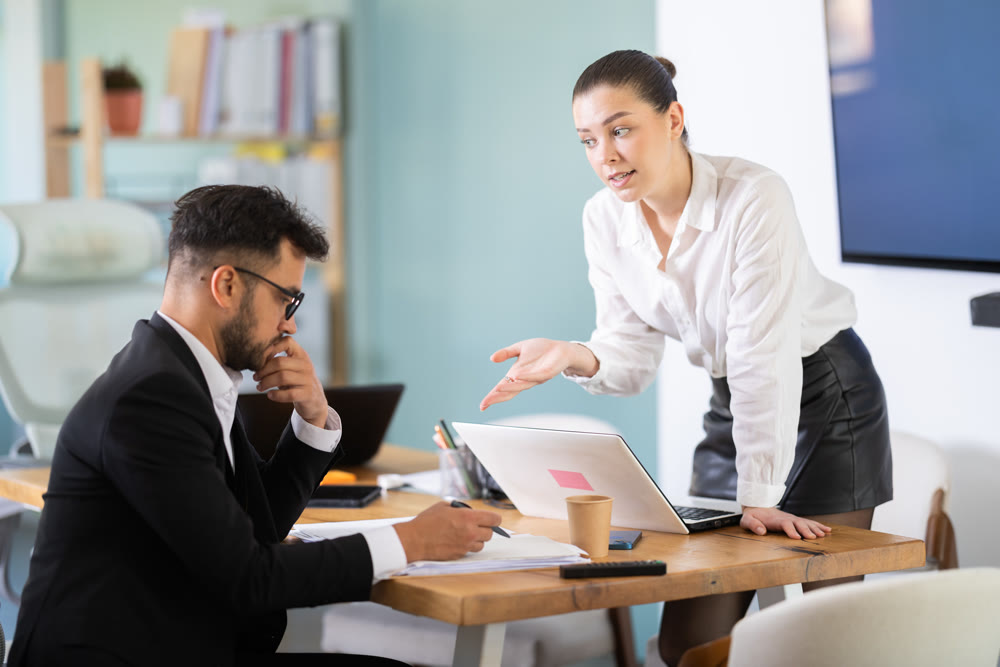 Colleagues business partners at office discuss financial data project documents paperwork