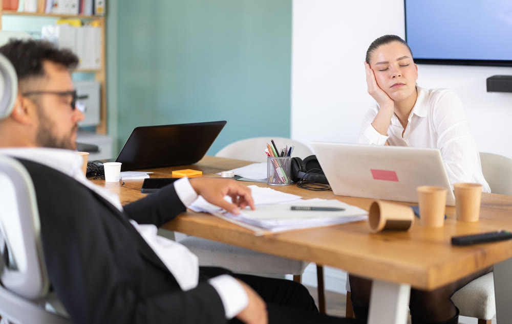 Tired man and girl sleeps next to computer at work