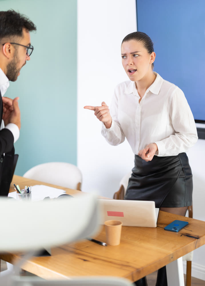 Man and woman arguing in the middle of the office