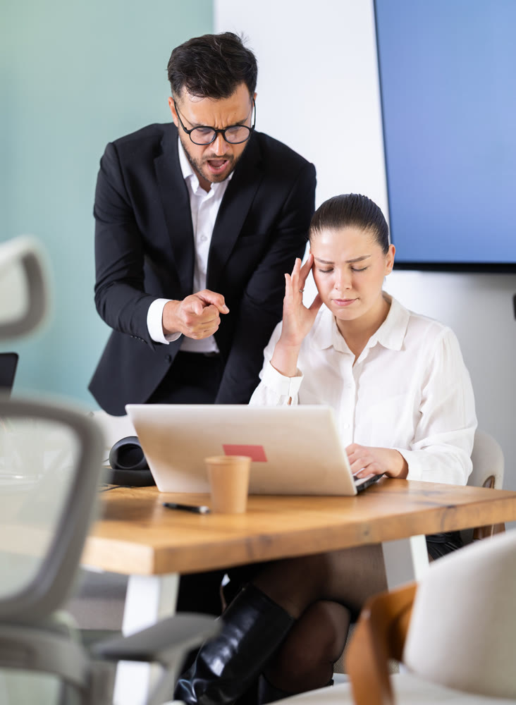 Male boss yells at woman employee, girl work at computer and reprimanded by management
