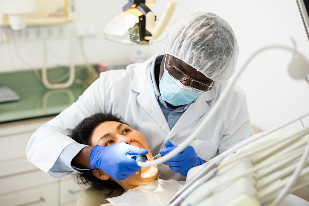 Closeup view of dentist treating teeth of woman in dentist office