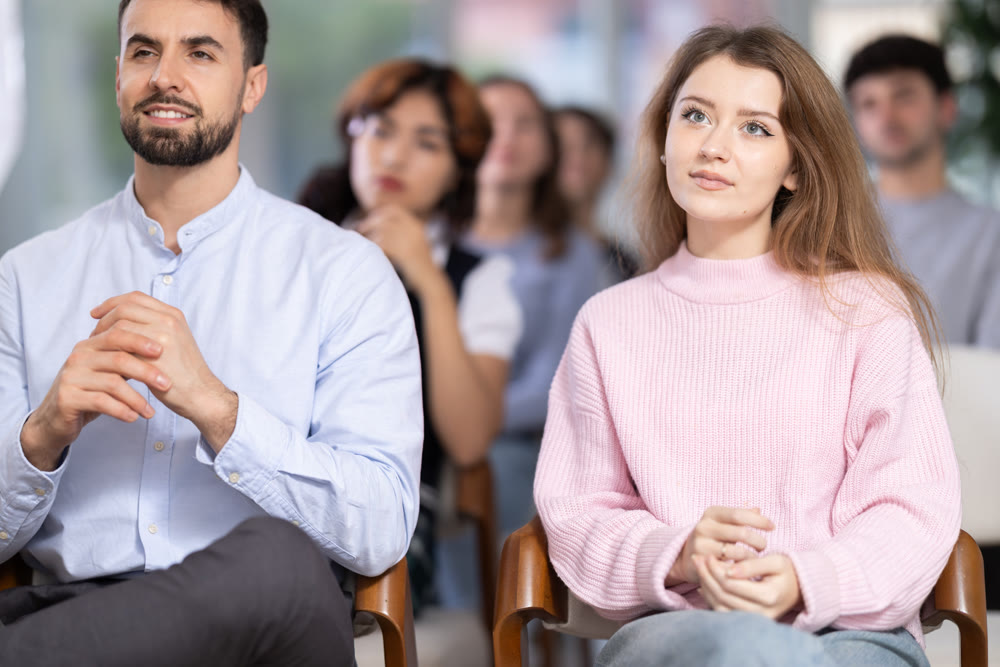 Young people are listening to lecture in auditorium